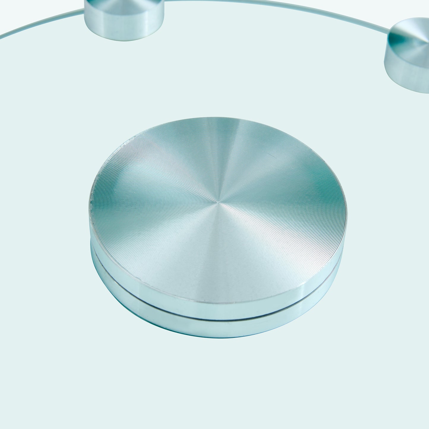 Brushed aluminum round base with concentric rings part of a modern bathroom scale