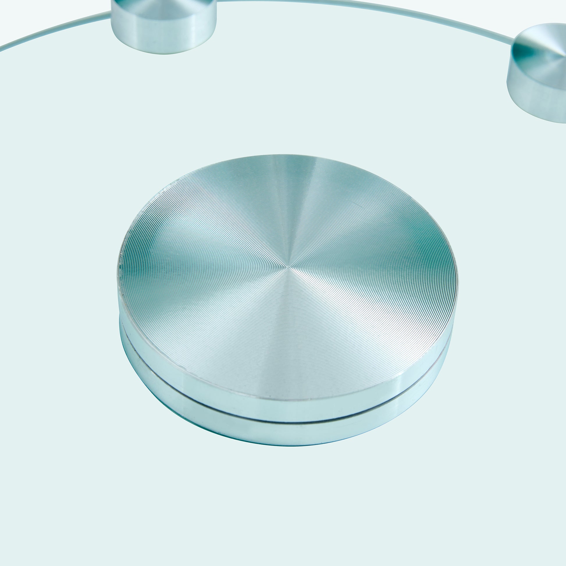 Brushed aluminum round base with concentric rings part of a modern bathroom scale