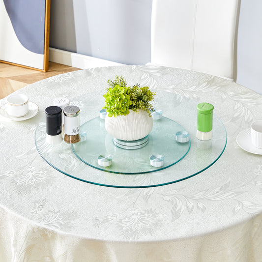 Clear glass Lazy Susan with chrome accents on a white damask tablecloth