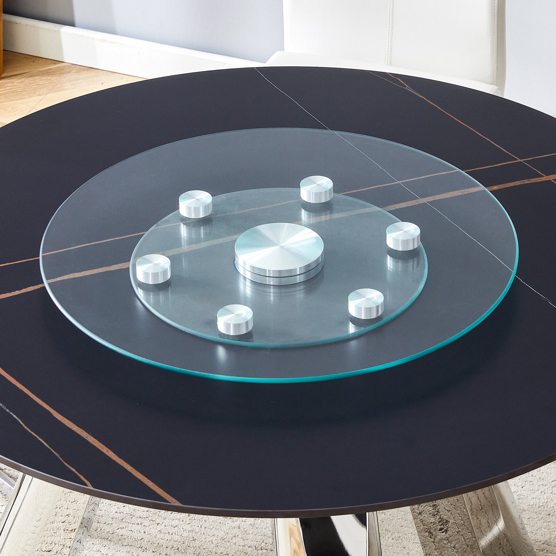 Black marble dining table with rotating glass lazy susan and chrome accents