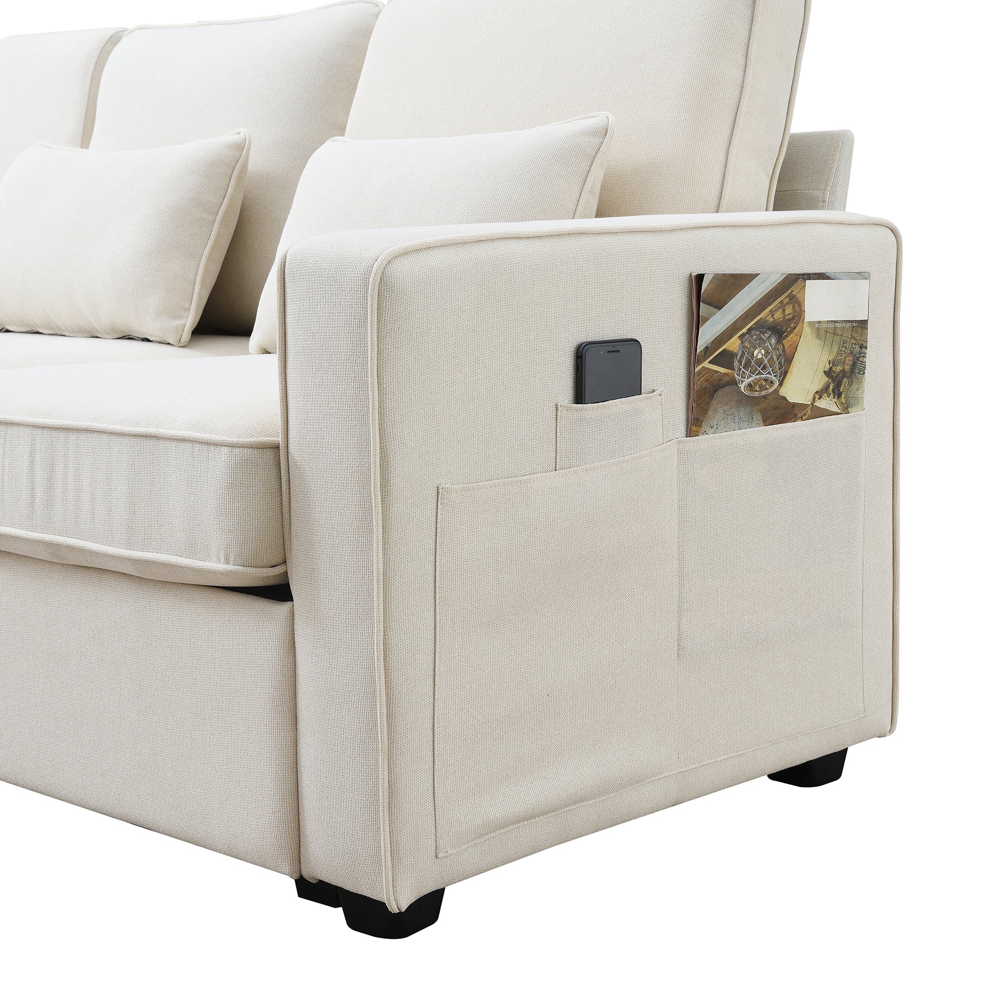 Cream fabric sofa with convenient side pocket for magazines and phone storage