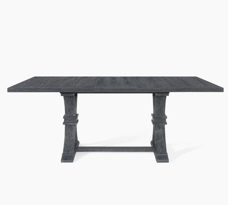 Dark charcoal oak dining table with carved pedestal legs and robust base