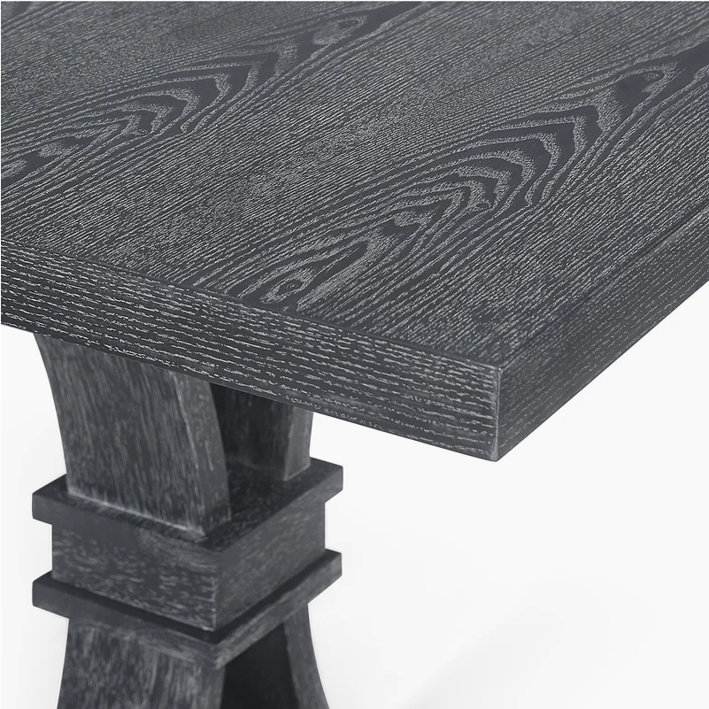 Dark grey wooden dining table with visible grain and sturdy trestle base
