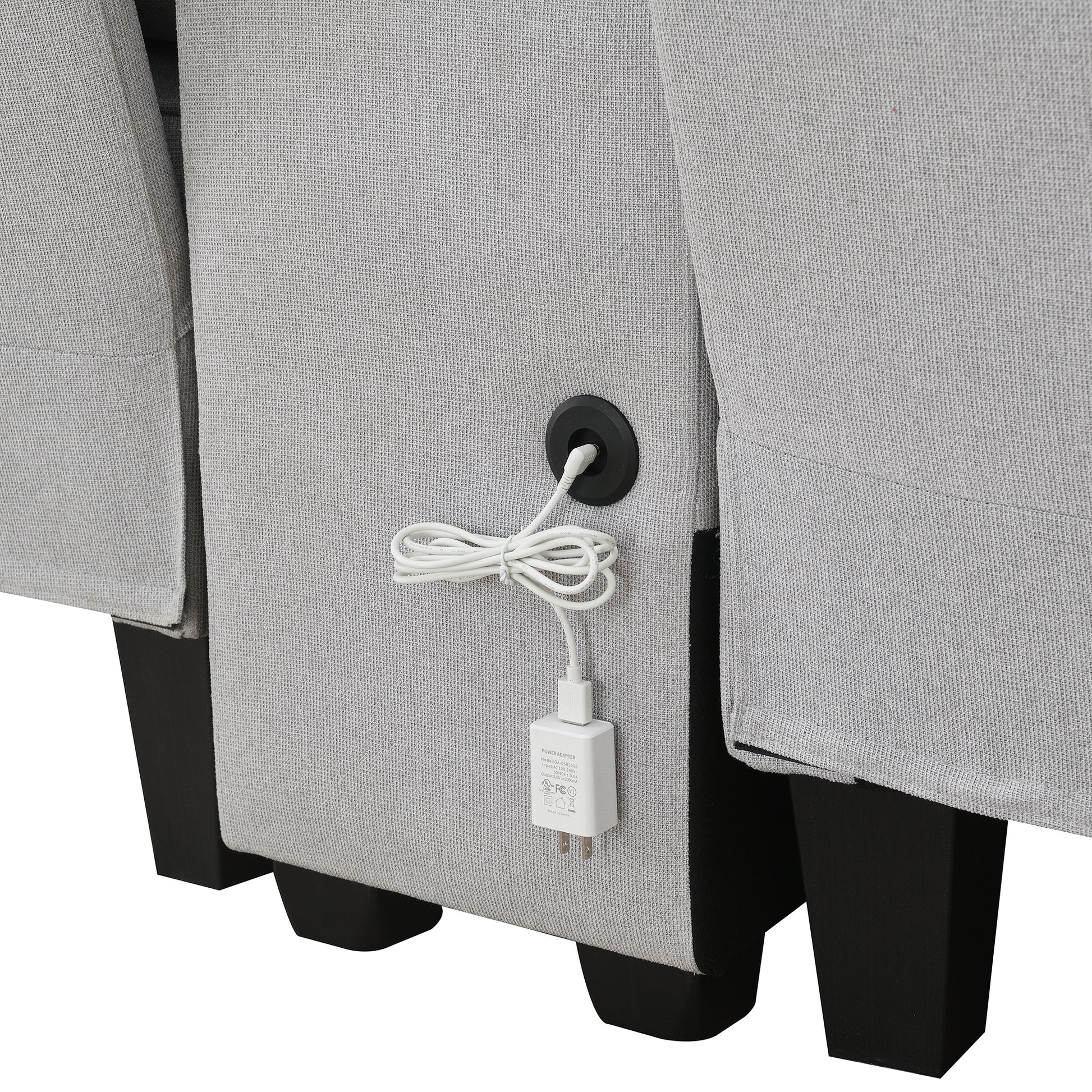 Light gray fabric sofa with integrated USB charging port and power adapter
