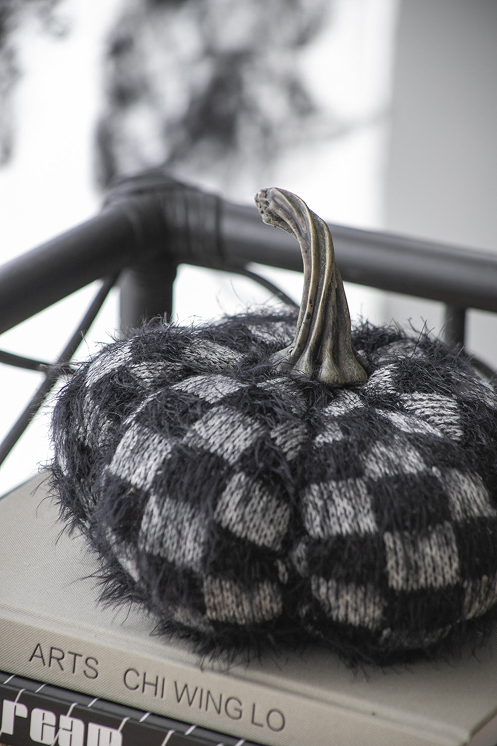 Black and white checkered fuzzy pumpkin decor with metal stem
