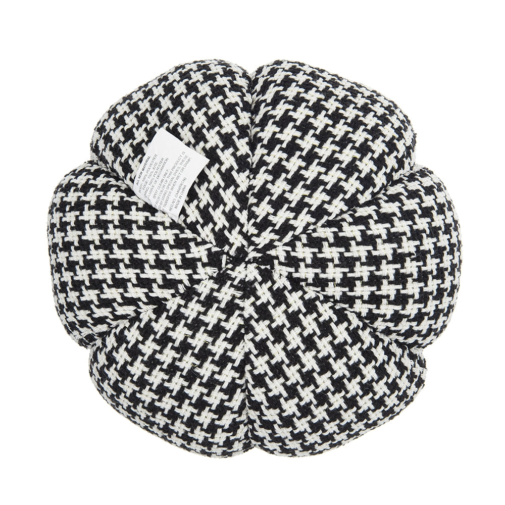 Black and white houndstooth throw pillow with a flowerlike design and fabric tag