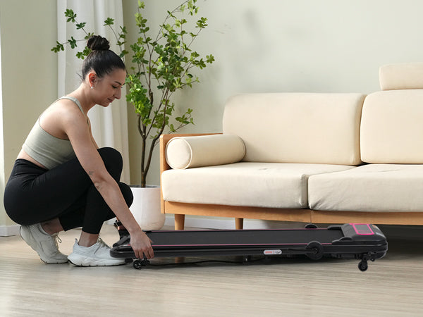 Slim black foldable treadmill with pink accents ideal for compact home gyms