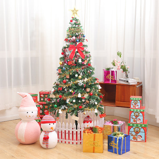 Fully decorated artificial Christmas tree with red bow and ornaments