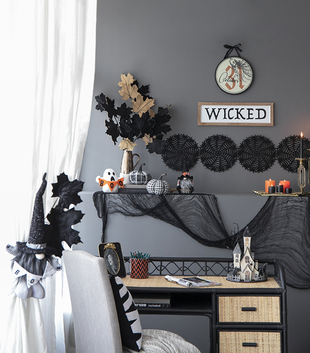 Black and gold faux leaves in a metallic vase perfect for Halloween decor