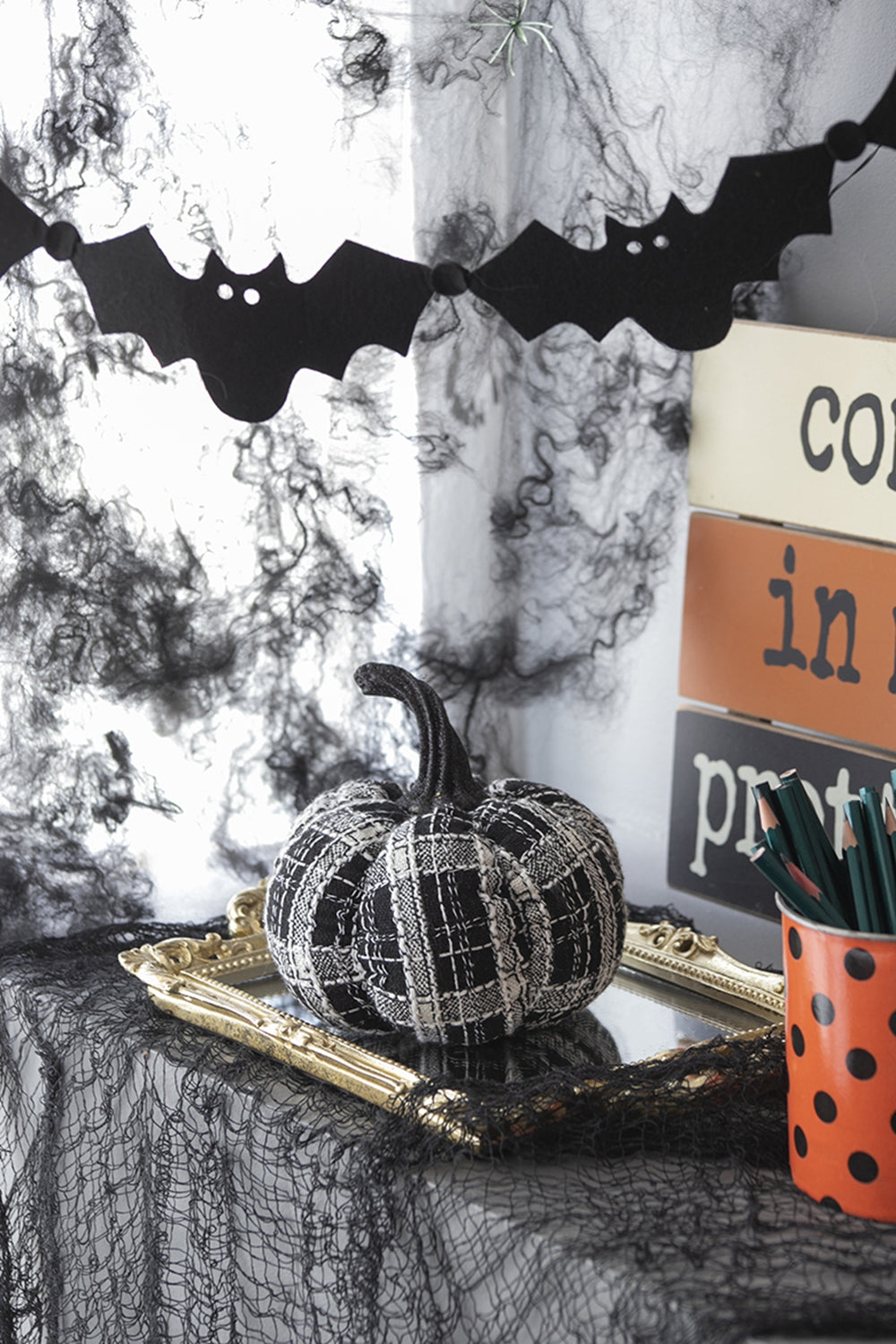 Textured fabric pumpkin with black and white plaid pattern for Halloween decor