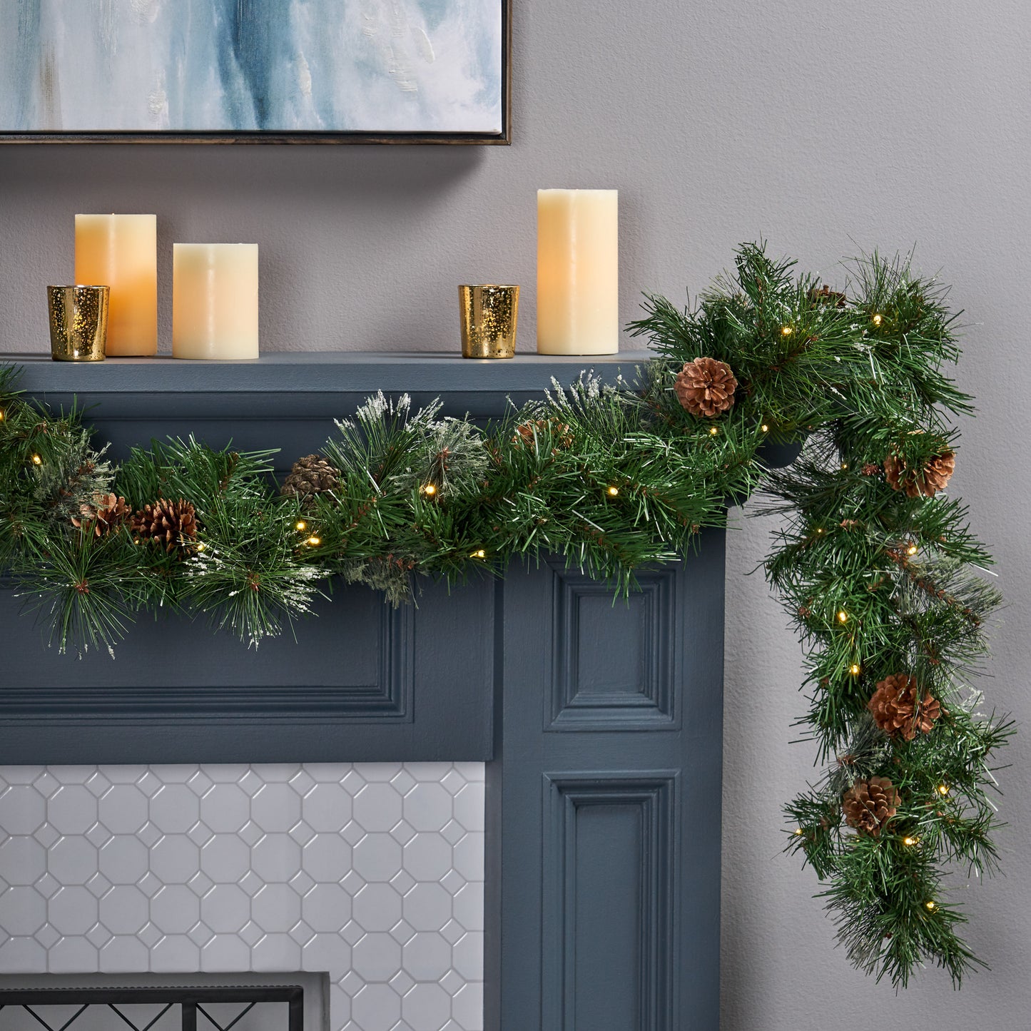 Realistic green pine garland with warm LED lights and pinecones