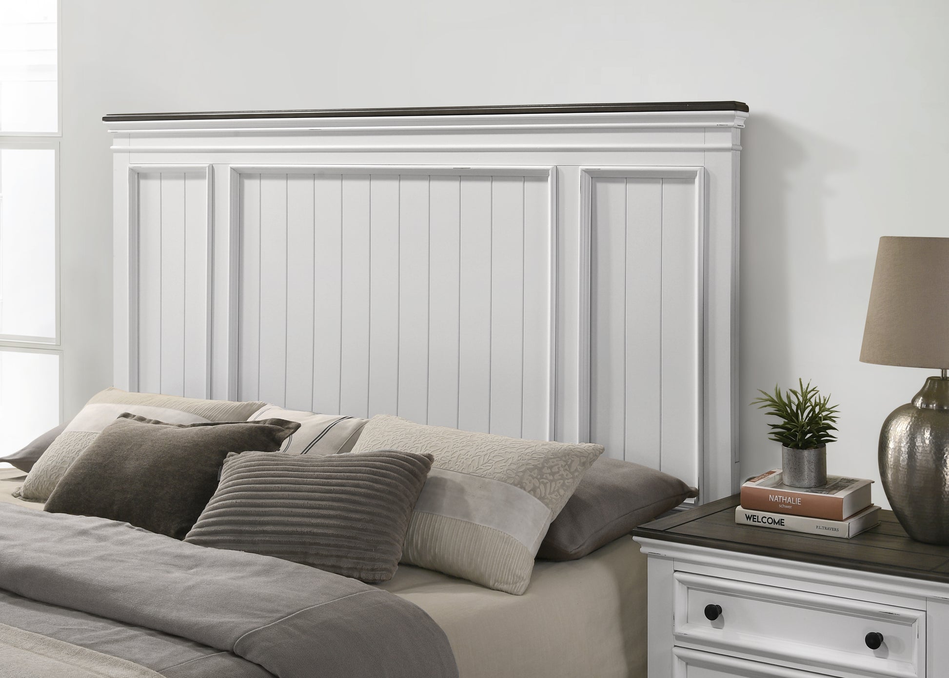White wooden headboard with dark wood trim and panel detailing