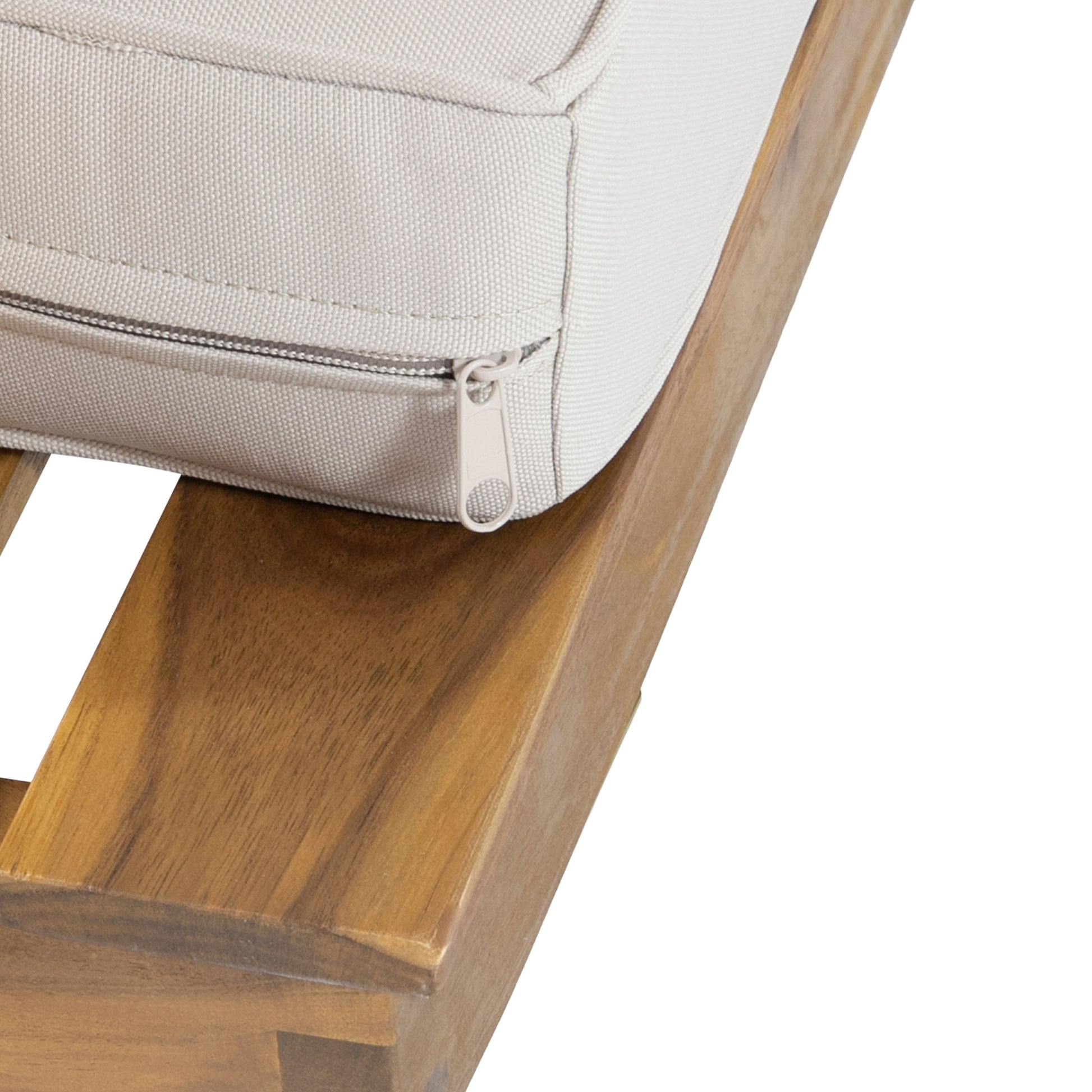 Closeup of a beige outdoor furniture cushion with a light gray zipper on a wooden base