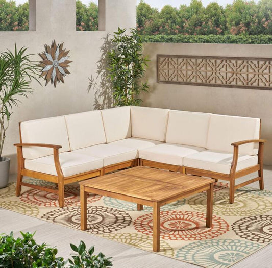 Acacia wood outdoor sectional sofa with cream cushions and a matching coffee table