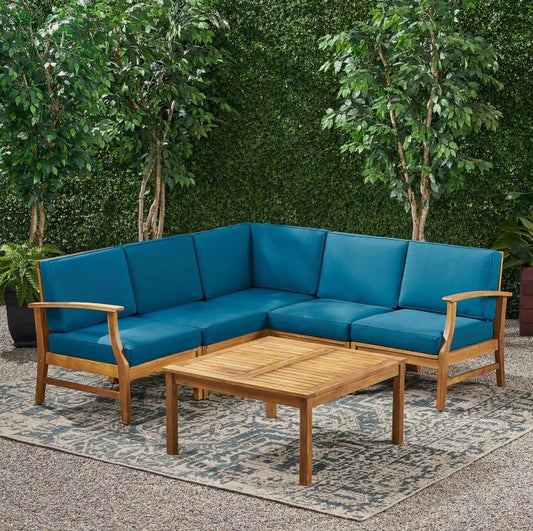 Teak wood sectional patio sofa with vibrant teal cushions and matching coffee table