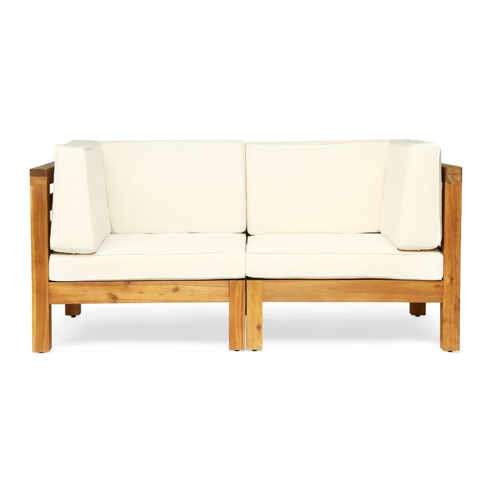 Twoseater wooden patio sofa with cream cushions perfect for outdoor seating