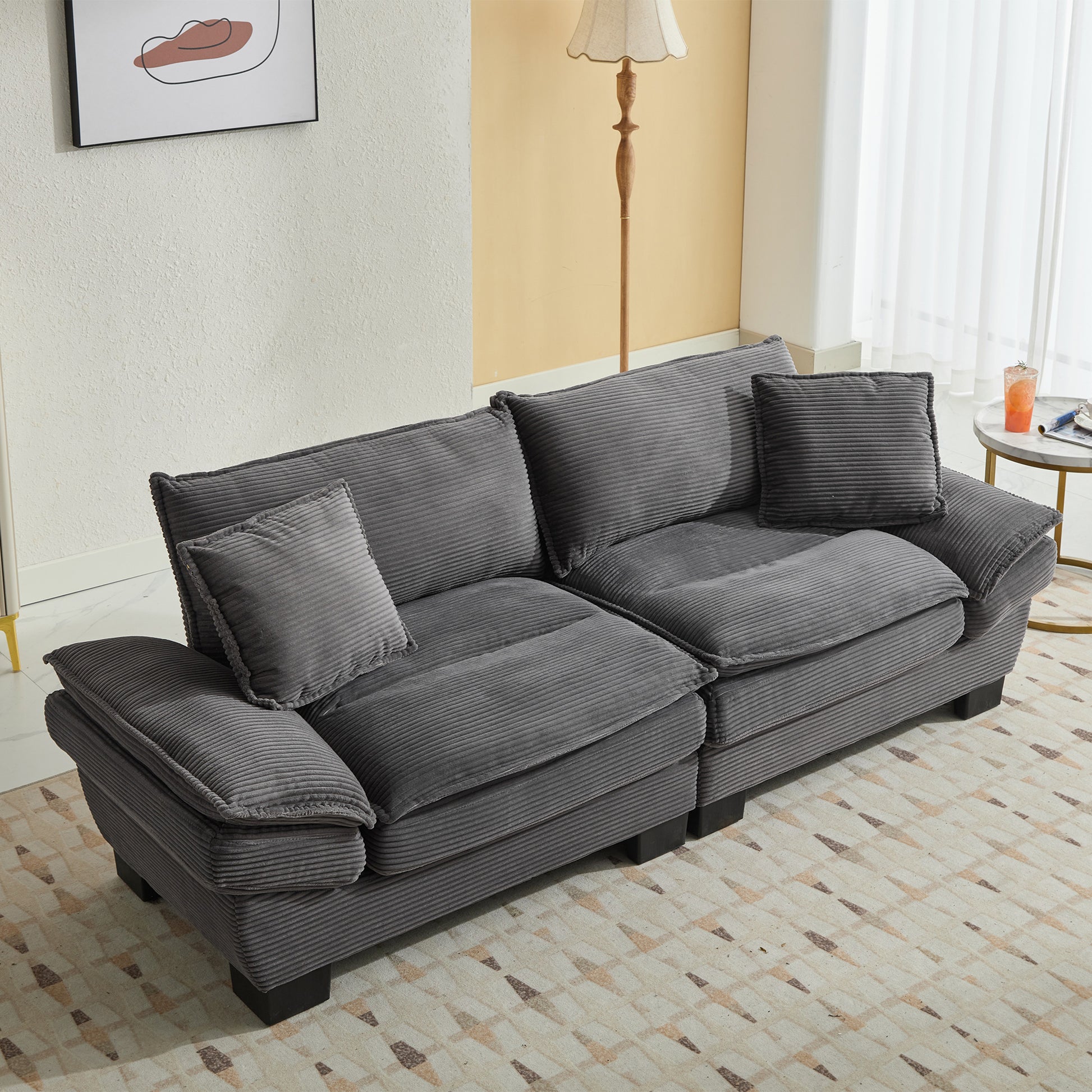 Comfortable dark gray corduroy sectional sofa with plush cushions and throw pillows