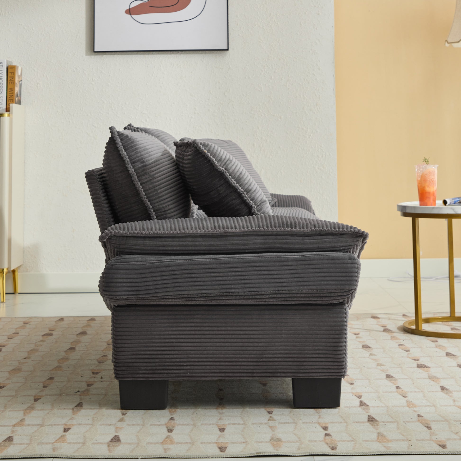 Dark grey corduroy loveseat with plush cushions perfect for cozy living rooms