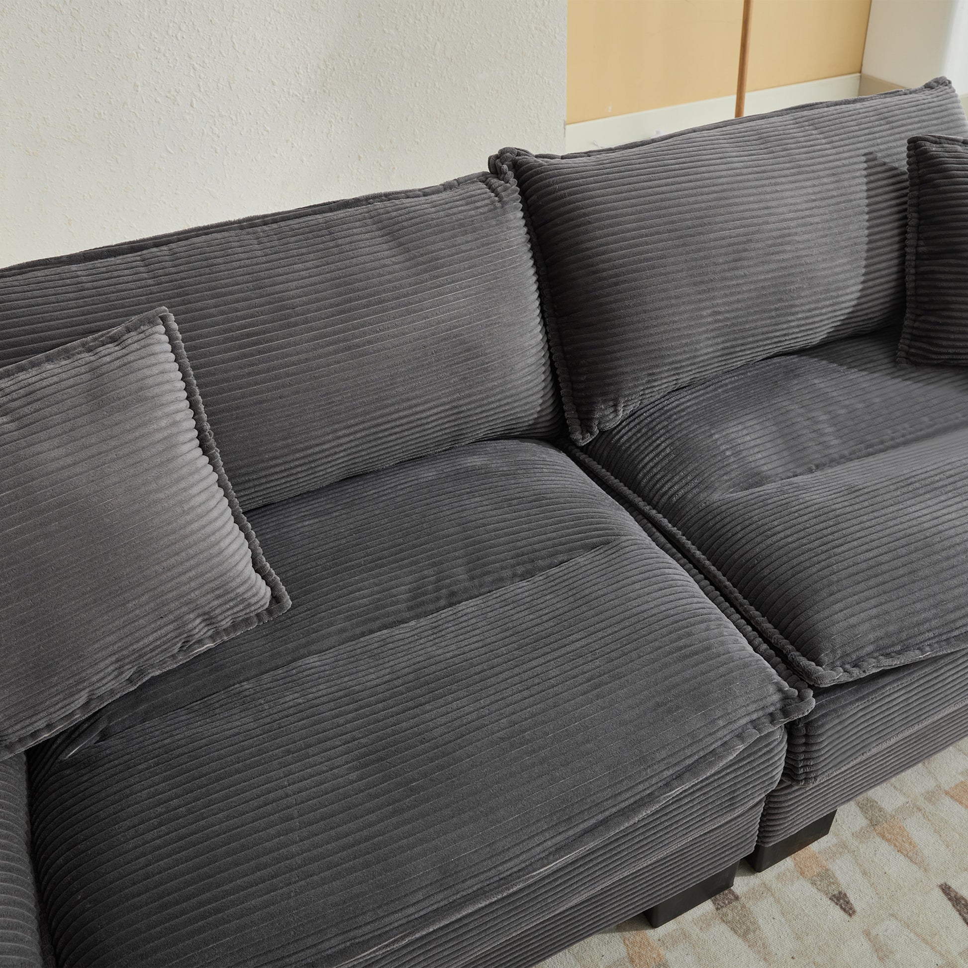 Deep grey corduroy sectional sofa with plush cushions