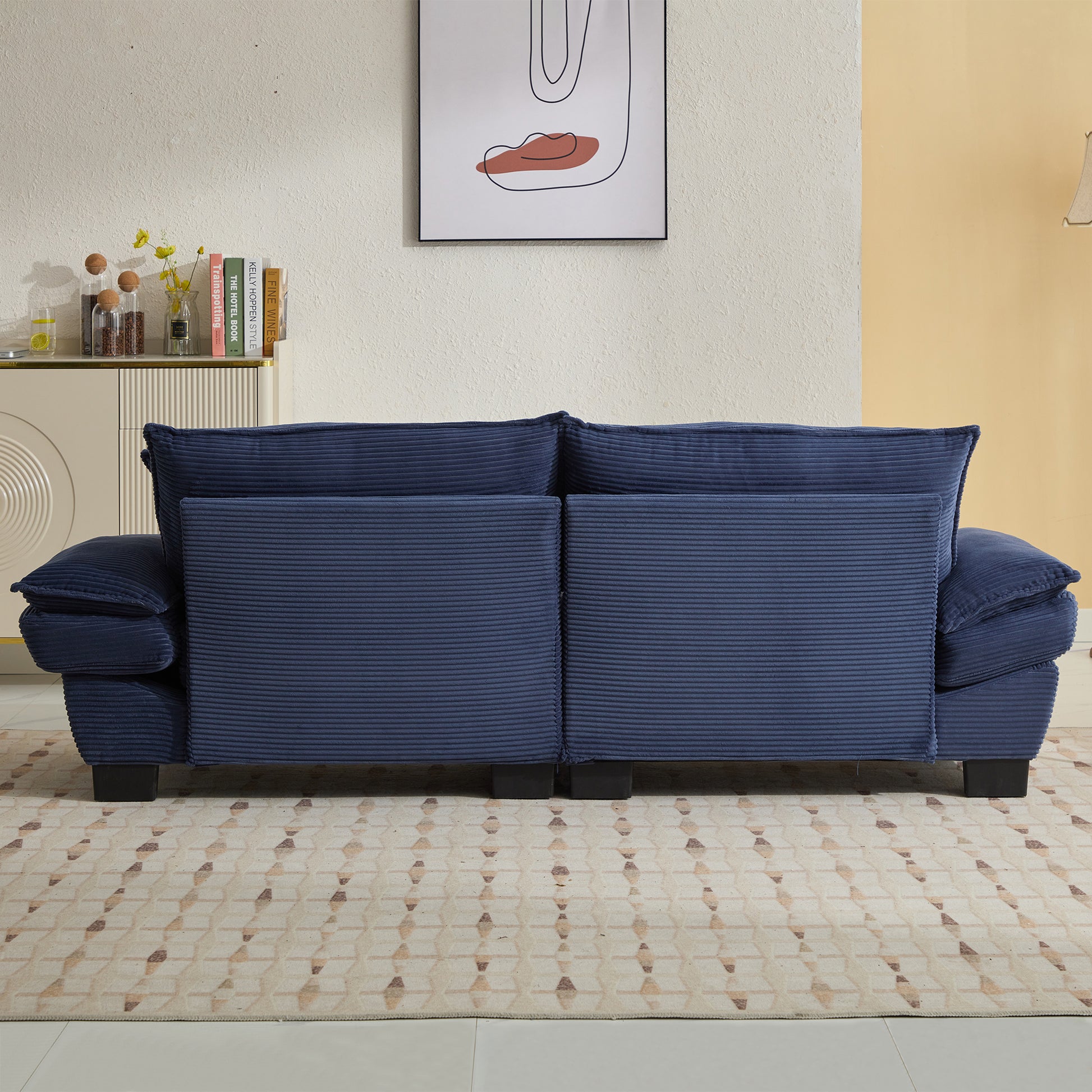 Navy blue corduroy sofa with plush cushions a stylish modern living room centerpiece