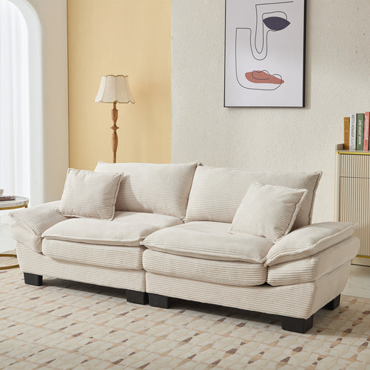 Plush cream corduroy sofa with plush seat cushions and matching throw pillows perfect for a cozy living room