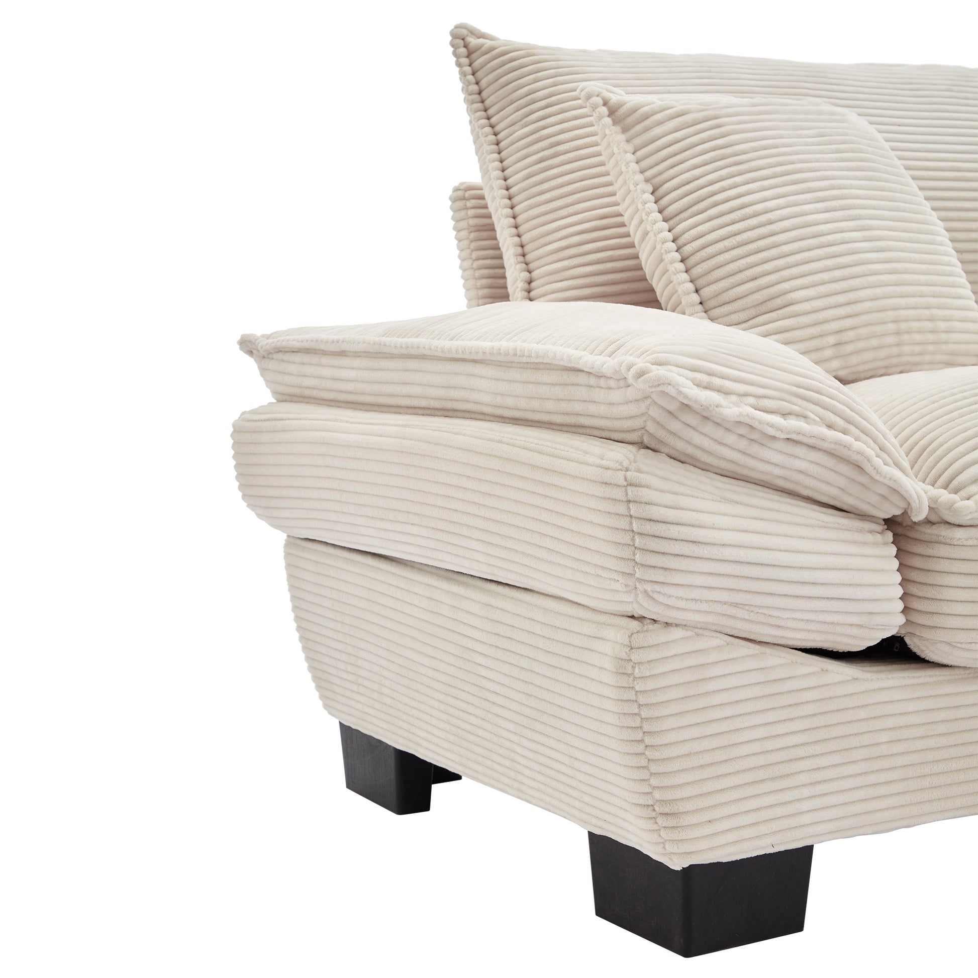 Closeup of a plush cream corduroy sofa armrest and cushions with dark wood feet