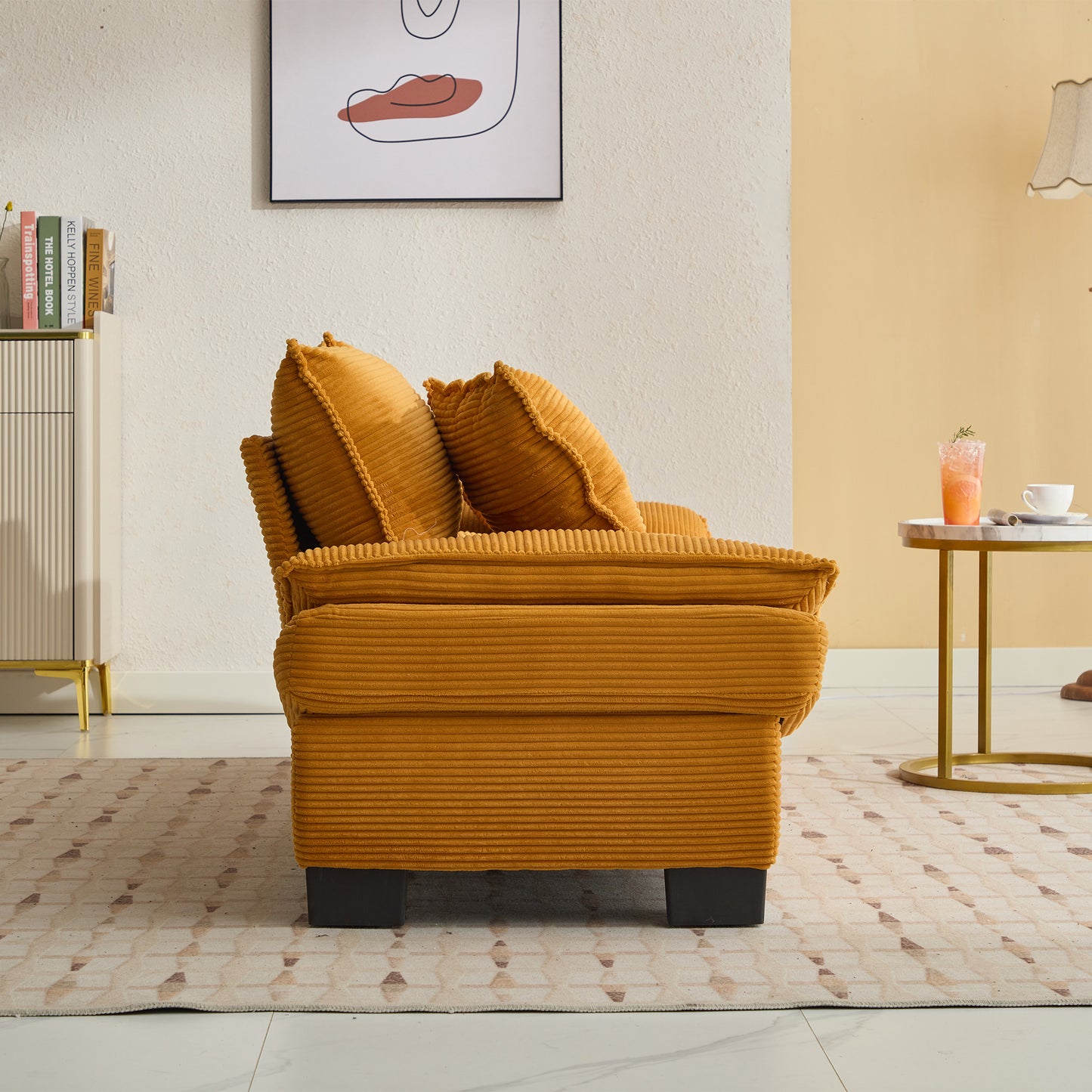 Comfortable mustard yellow corduroy sofa with plush cushions and dark wood legs