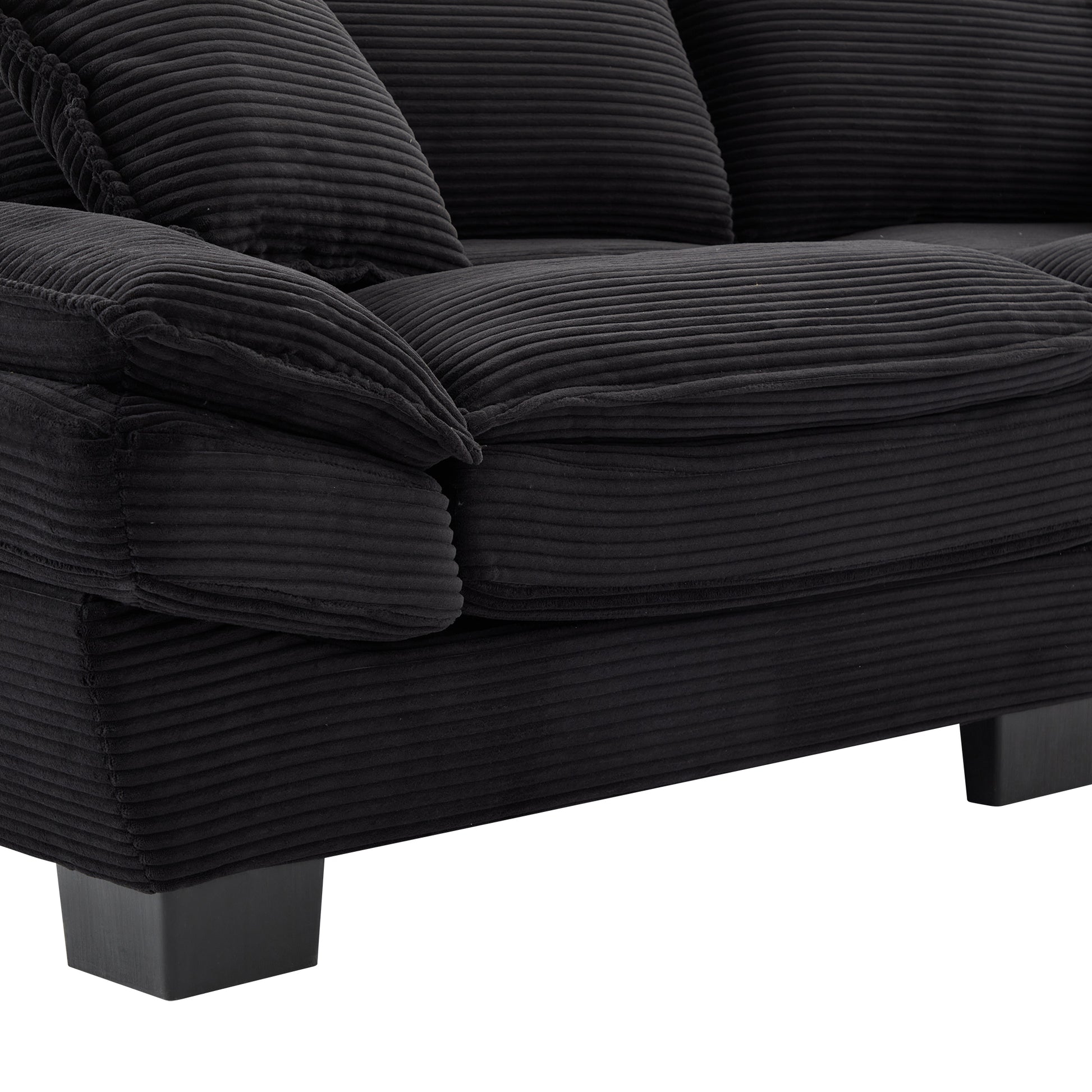Plush black corduroy sofa with deep channels and plush cushions  Ideal for modern living rooms