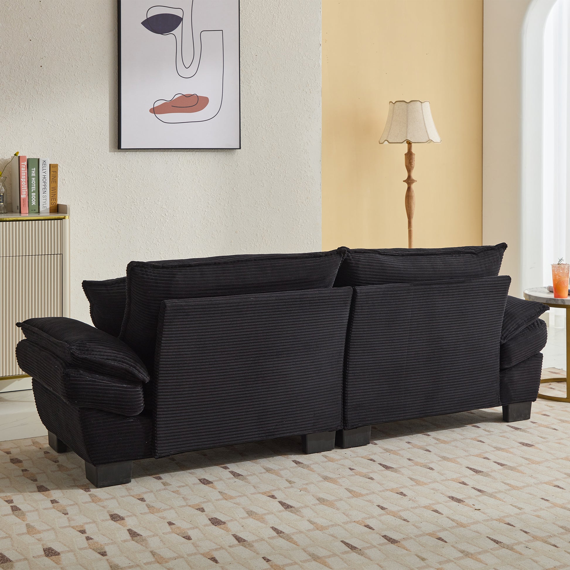 Black corduroy sofa with plush cushions ideal for a modern living room setup