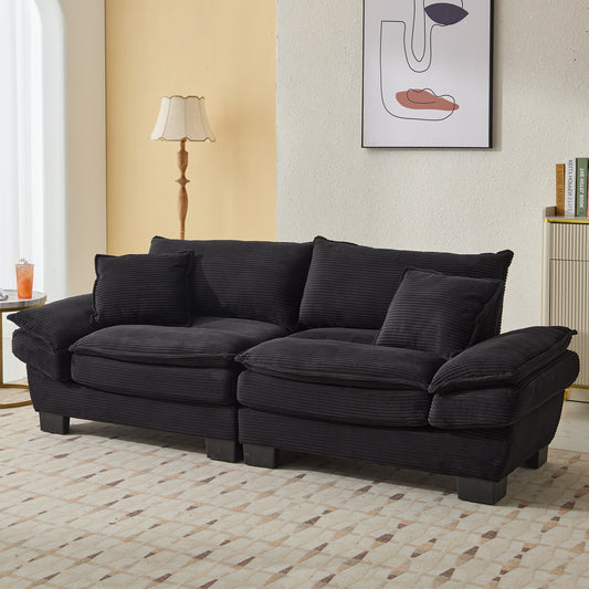 Deep charcoal corduroy sofa with plush cushions and wooden legs ideal for modern living rooms