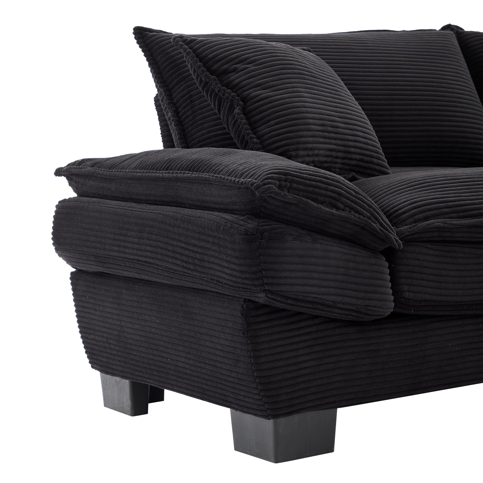 Black corduroy sofa with plush cushions featuring textured fabric and modern square legs