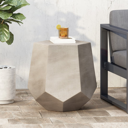 Geometric concrete side table with faceted design and minimalist style