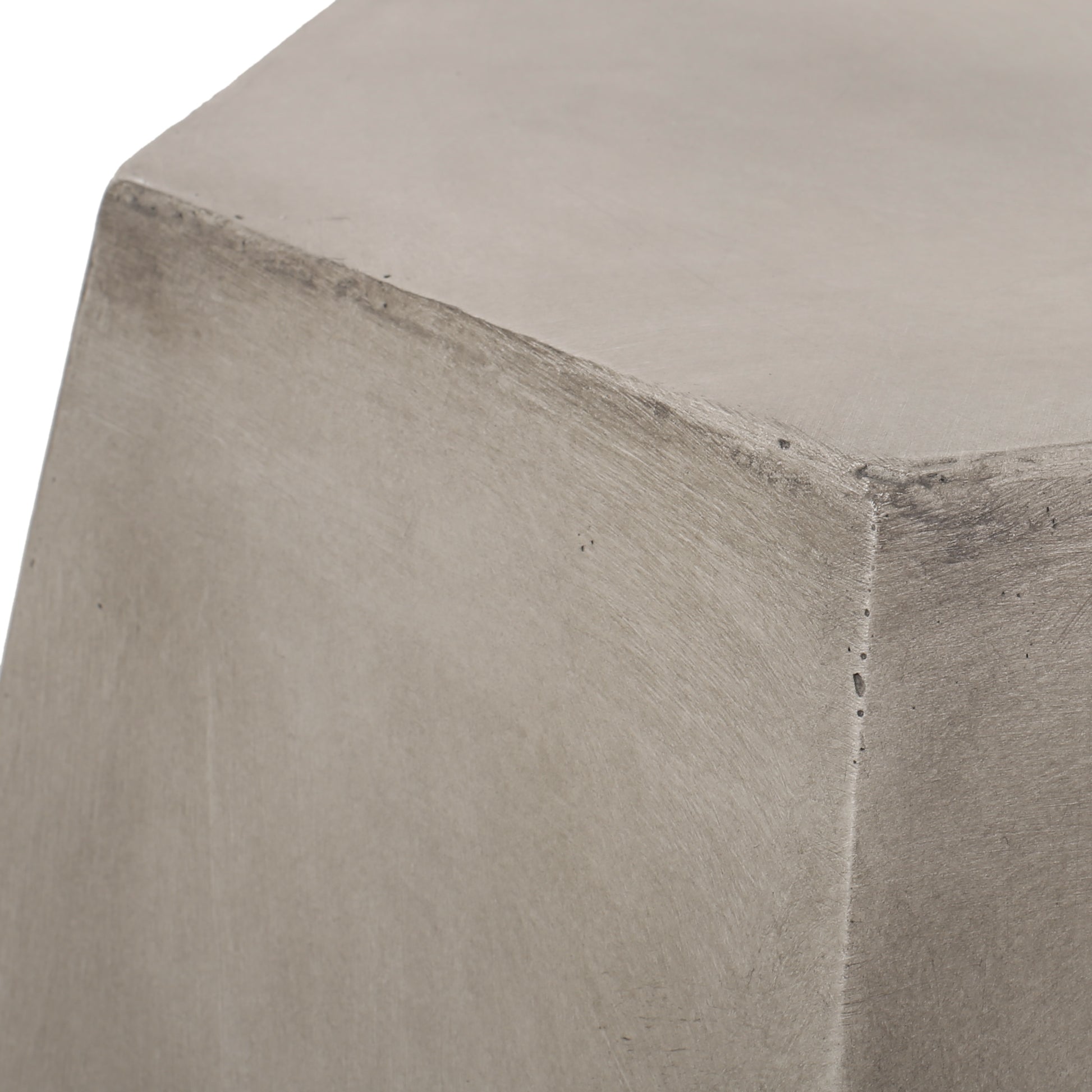 Closeup of a textured gray concrete block with subtle imperfections