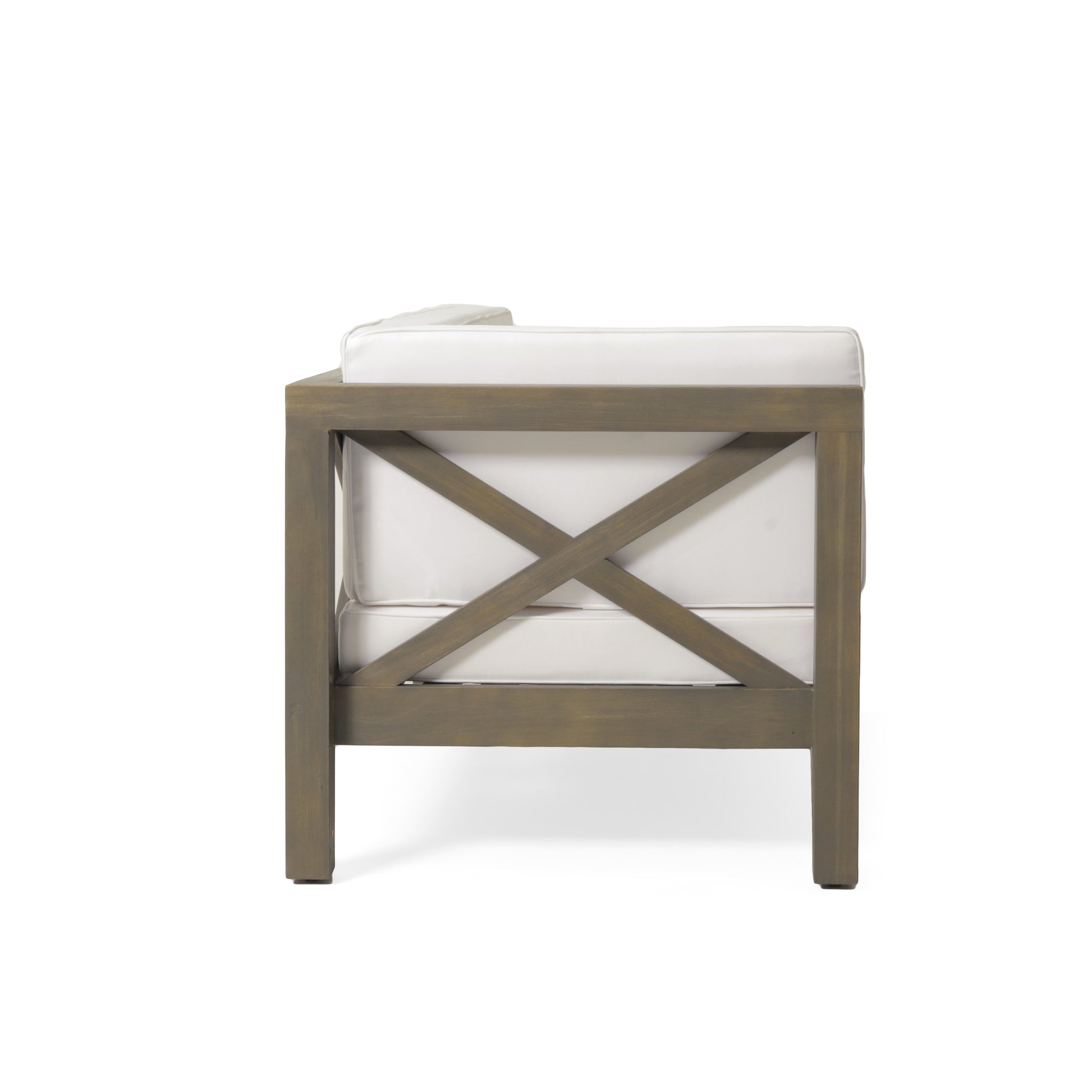 Side view of a gray wood outdoor armchair with white cushions and Xframe back