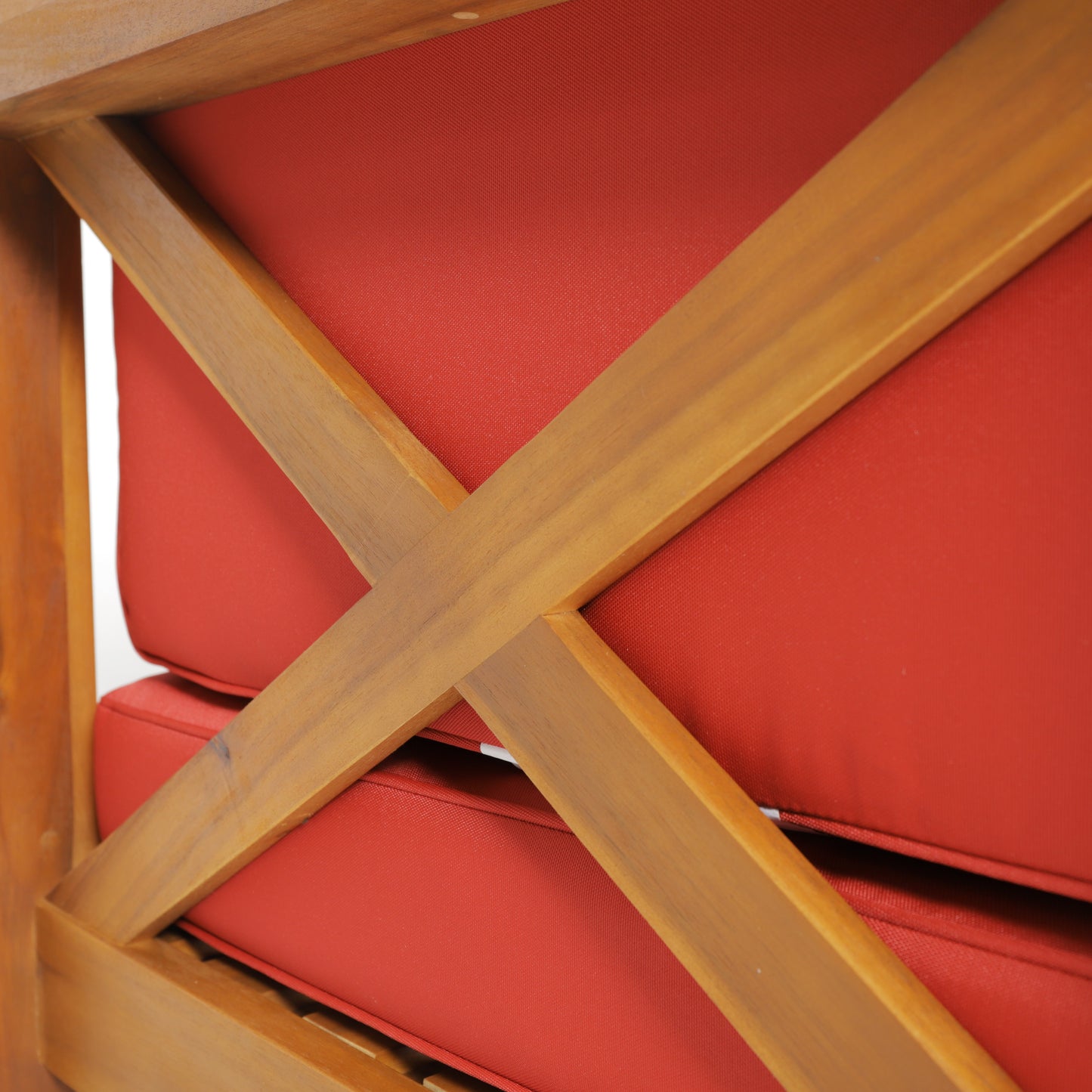 Wooden outdoor chair with plush red cushions and crossback detail