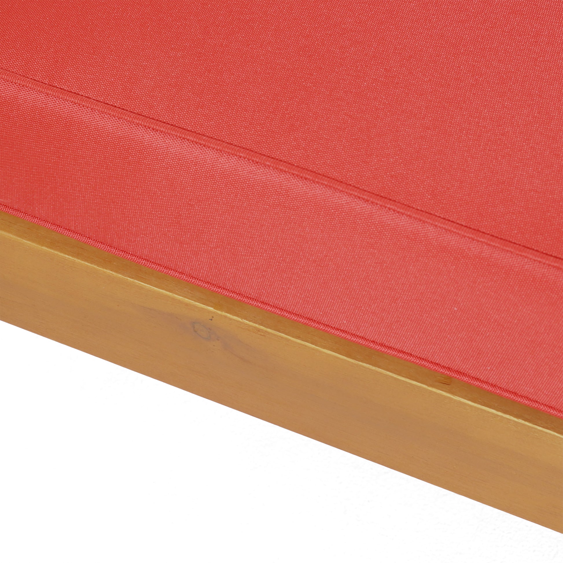 Closeup of a red outdoor cushion with a wooden frame perfect for patio furniture