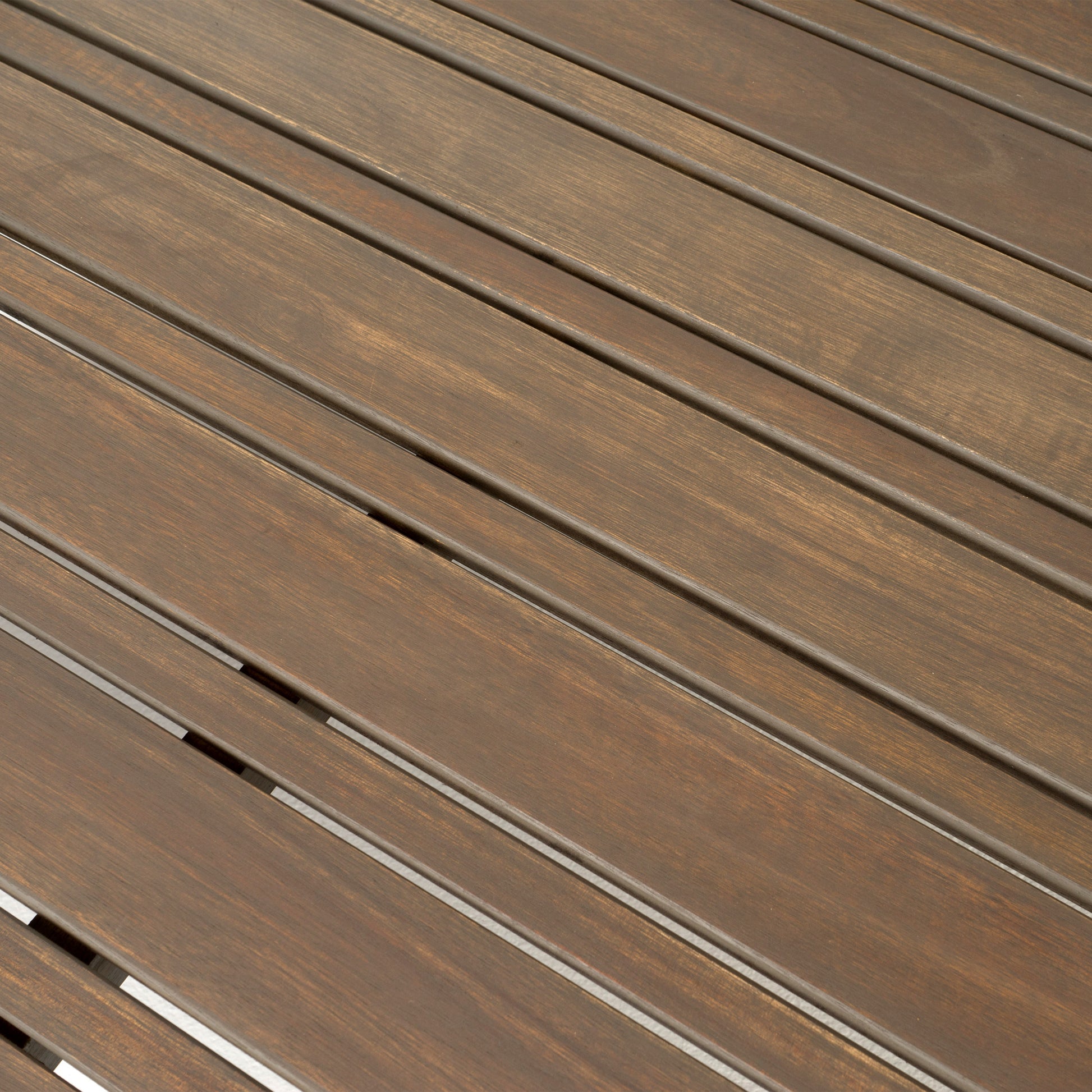 Close up of rich dark brown wood slats with visible grain for outdoor furniture