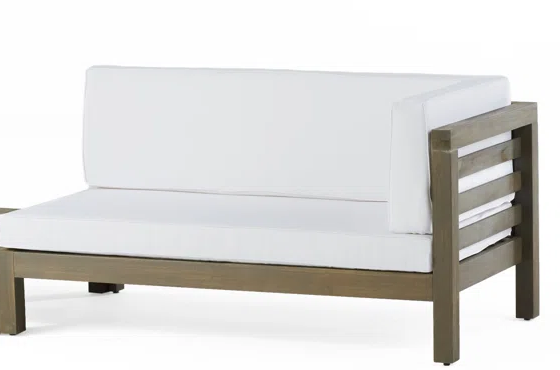 Modern teak sectional outdoor sofa with plush white cushions