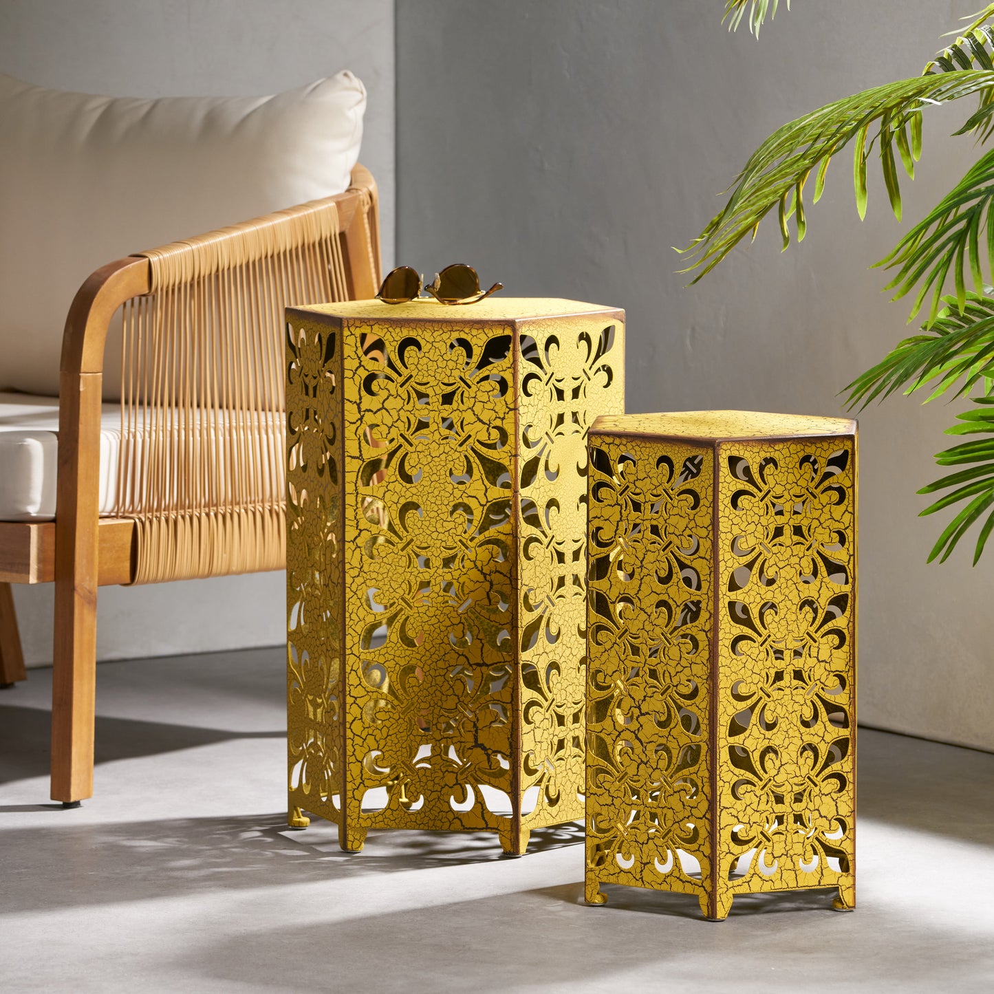 Set of two distressed gold hexagonal accent tables with filigree cutouts