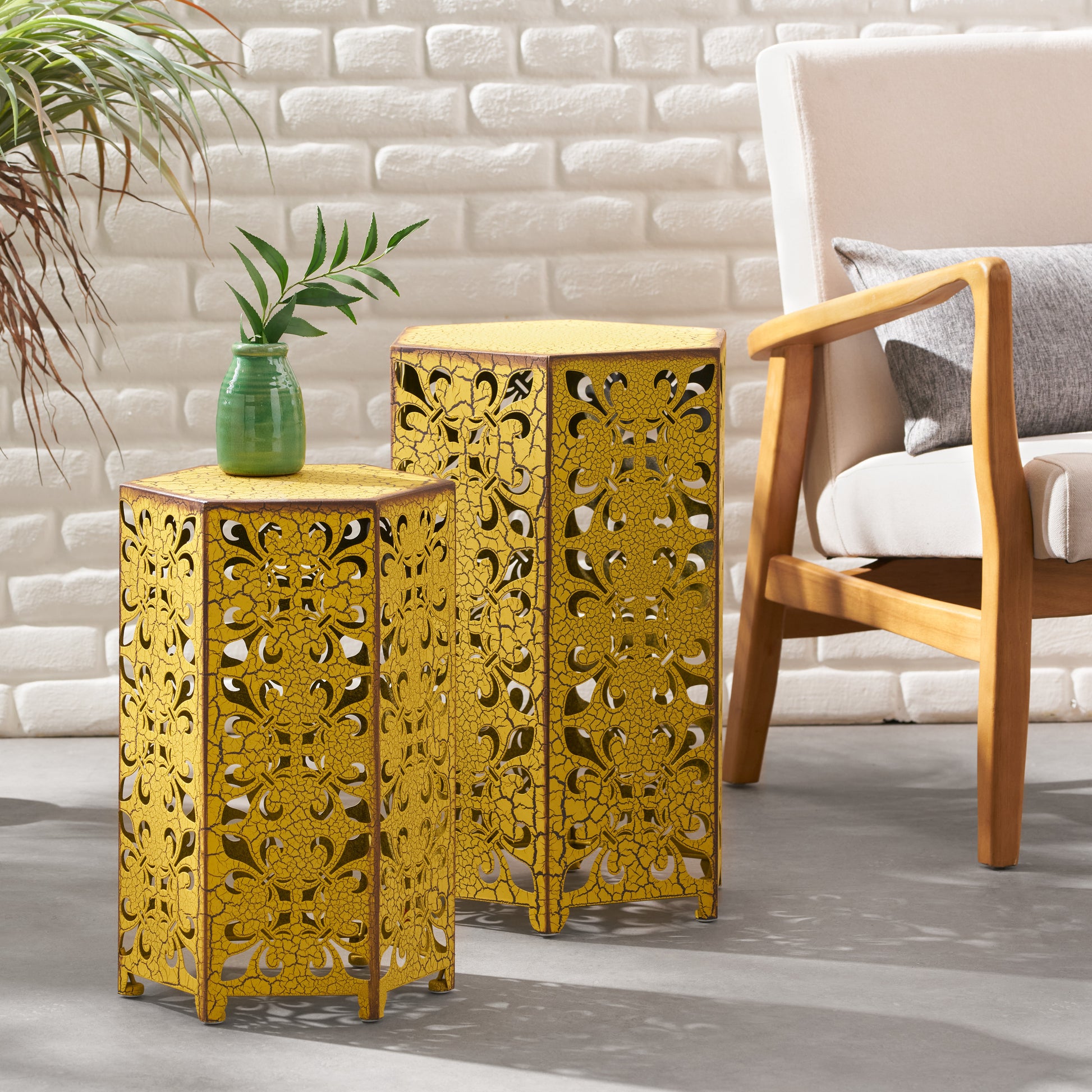 Yellow ornate metal side table with floral cutouts and antique finish