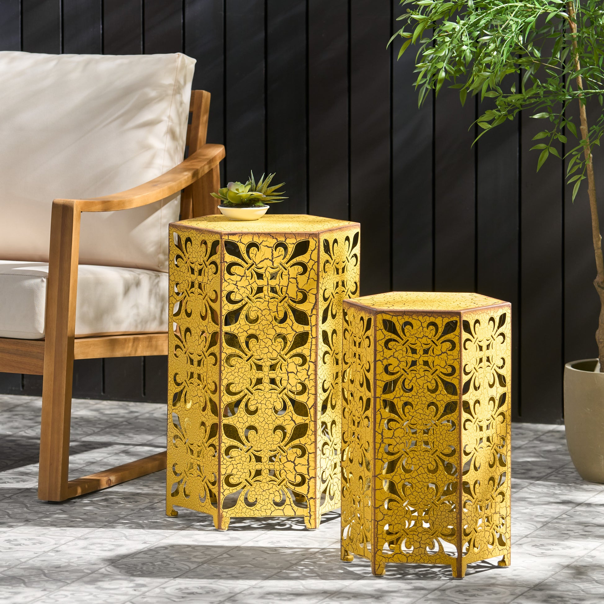 Pair of distressed gold metal side tables with intricate scrollwork
