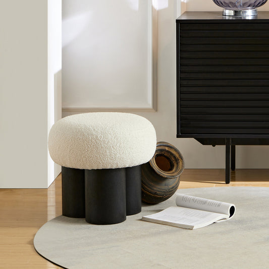 Cream boucle ottoman with black wooden legs a stylish accent piece