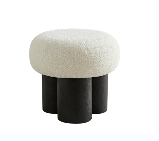 White boucl ottoman with dark wood cylindrical legs a stylish accent piece