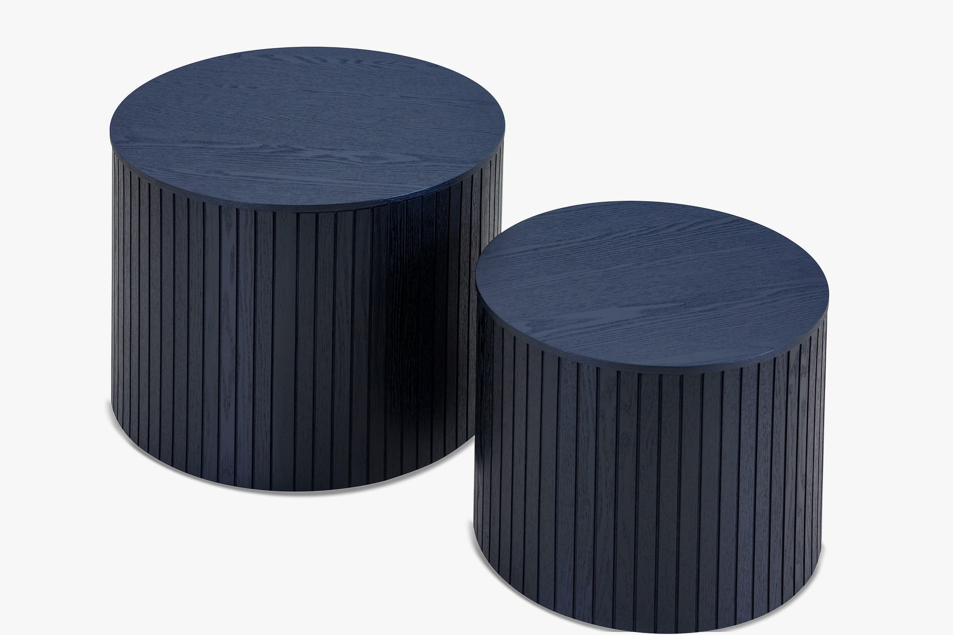 Two navy blue round wooden side tables with fluted texture modern design