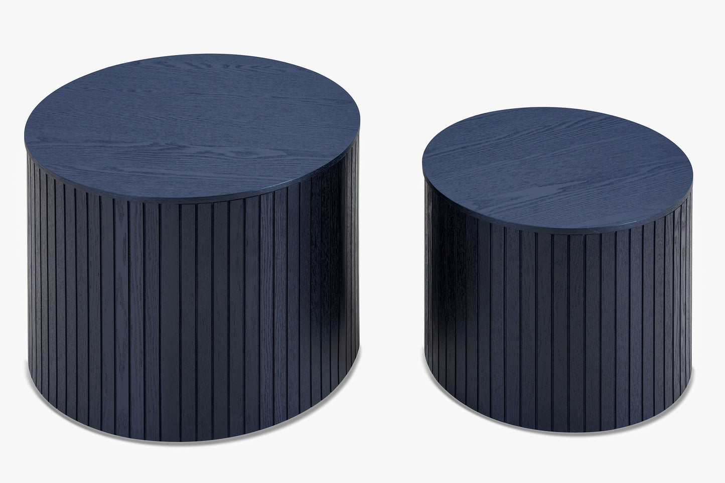 Two dark blue wooden drum side tables with fluted detailing