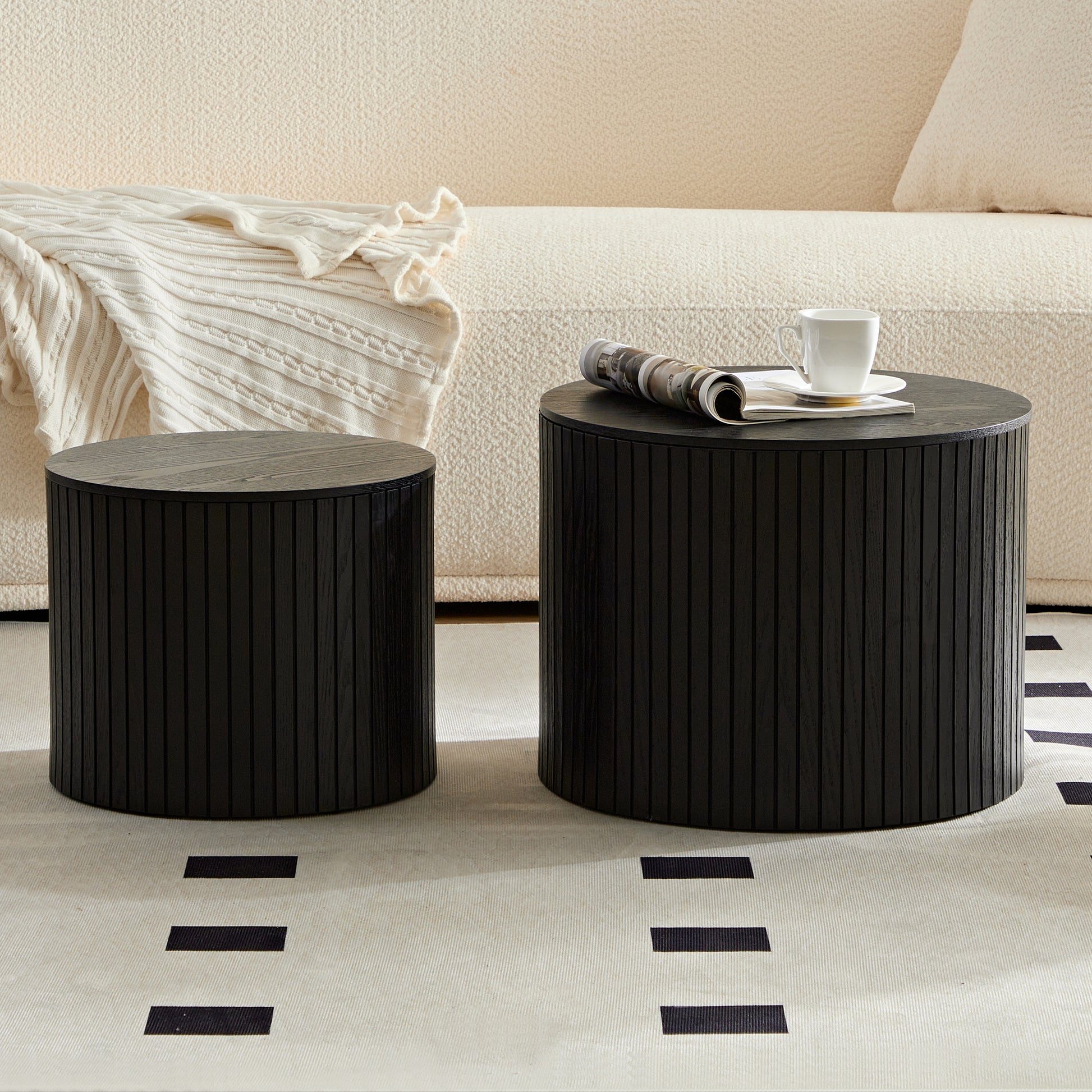Round black wood side table with fluted design and magazine rack
