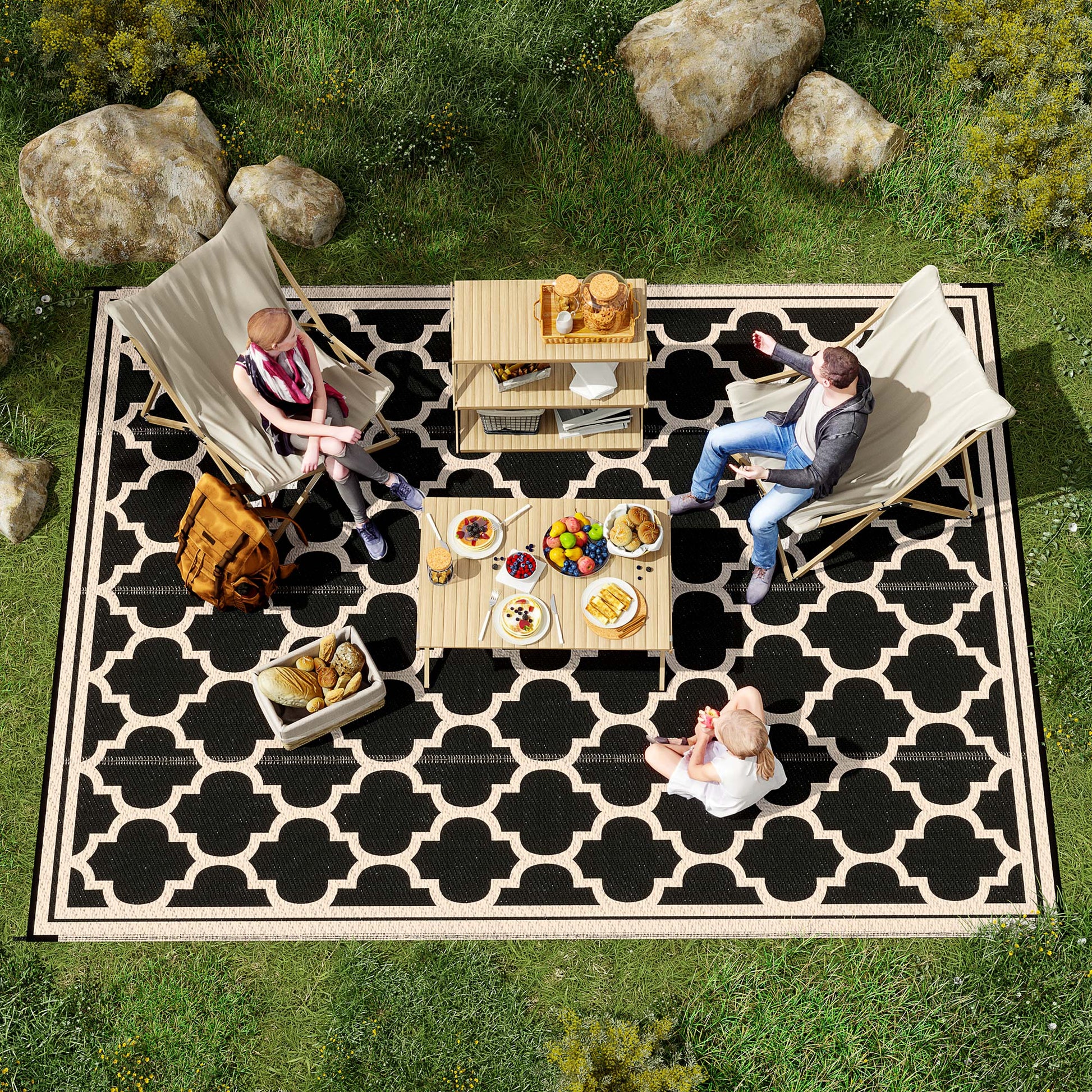 Black geometric outdoor rug with white quatrefoil pattern perfect for patios