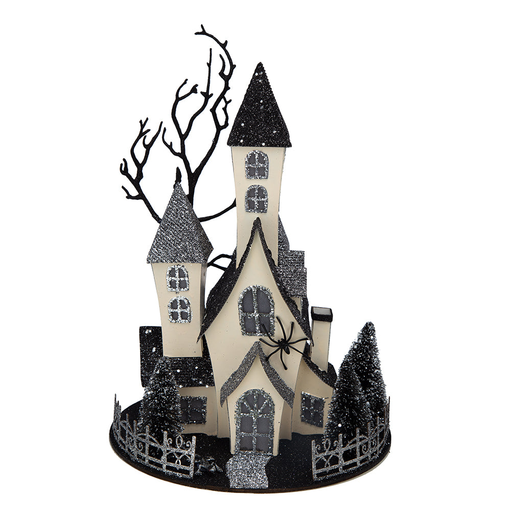 Glittered haunted house decor with spooky trees and a spider accent