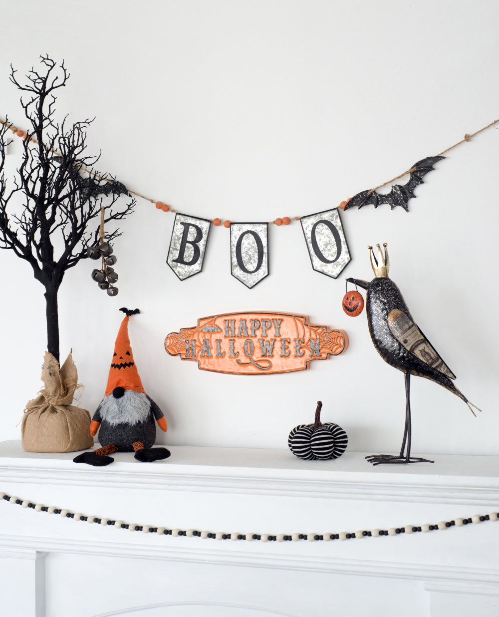 Glittery black bat garland with rustic rope and orange bead accents for Halloween decor