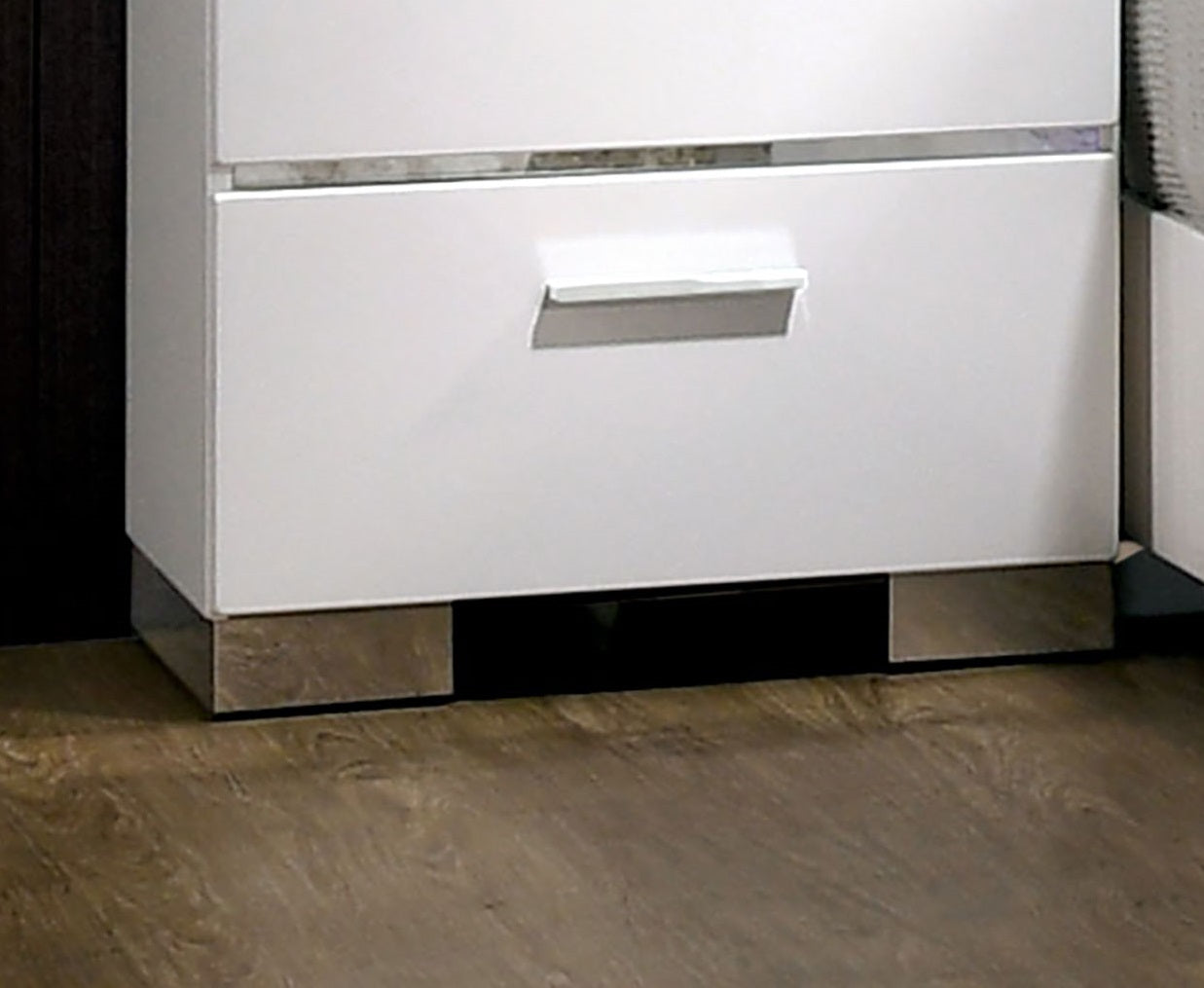 White modern nightstand with a single drawer and brushed metal base
